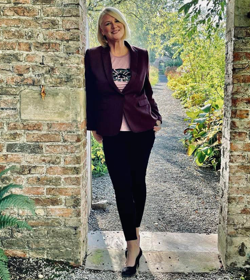 Anna in a garden doorway
