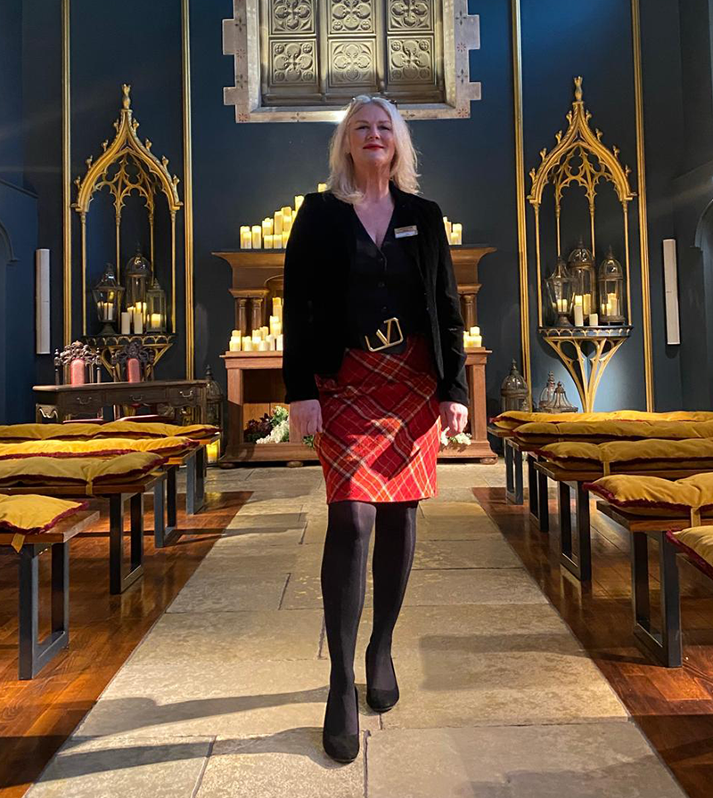 Anna in a chapel aisle with candles